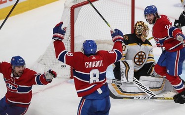 Canadiens defenceman Ben Chiarot celebrates his game-winning goal as teammates Tomas Tatar, left, and Phillip Danault look to congratulate him Tuesday night at the Bell Centre.