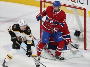 Montreal Canadiens centre Ryan Poehling gets between goaltender Carey Price and Boston Bruins' Sean Kuraly during first period in Montreal on Nov. 5, 2019.