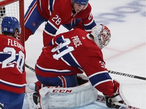 Montreal Canadiens defenceman Mike Reilly (28) and Montreal Canadiens goaltender Carey Price during second period NHL action in Montreal against the Boston Bruins, on Tuesday November 5, 2019.