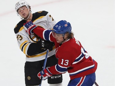 Montreal Canadiens' Max Domi (13) and  Boston Bruins' Charlie McAvoy (73) mix it up at centre ice, during first period NHL action in Montreal on Tuesday November 5, 2019.