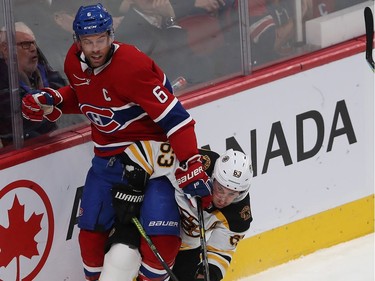 Montreal Canadiens Shea Weber (6) is sent into the boards by Boston Bruins' Brad Marchand (63), during second period NHL action in Montreal on Tuesday November 5, 2019.