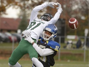 Keali Barker of the John Abbott Islanders grabs Sherbrooke Volontaires wide-receiver Leo Roy during CEGEP quarterfinal playoff game on Saturday.