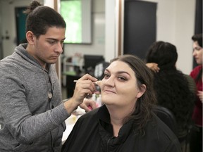 Lisa McIntyre-Therrien gets makeup applied by  Carlos Christodoulou at LaSalle College on Thursday. "I liked the beauty (session), the spa, the makeup," McIntyre-Therrien  said. "It's been nice. It's exciting."