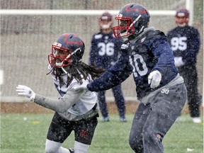 "I'm proud to be Canadian and that I've played in this country. I'm proud to have played this game up here as well,"said Alouettes linebacker Henoc Muamba, right, who held off receiver Ryan Shakeir practice on Thursday.