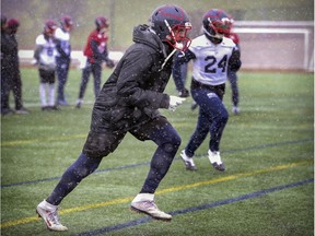 Receiver Eugene Lewis wears a parka while running pass routes as snow fell during Alouettes practice in Montreal on Nov. 7, 2019.  The Alouettes meet the Edmonton Eskimos in the Eastern Conference semi-final game on Sunday in Montreal.