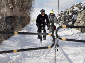 Eric Thibodeau, left, and Mario Grenier ride the south access ramp to the Jacques Cartier Bridge bike path in Montreal on Friday February 3, 2017.