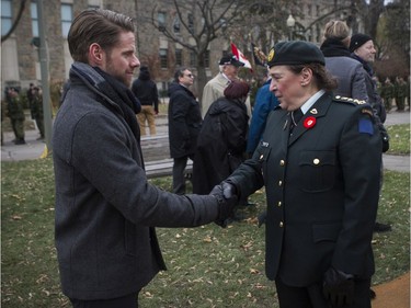 Captain Parker Donaldson, who served in Afghanistan in 2010-11 for Task Force 310, is thanked for his service by Honorary Colonel Jennifer Stoddart of the 34th combat engineering regiment at the Remembrance Day ceremony at the Westmount Cenotaph in Montreal on Sunday, Nov. 10, 2019.