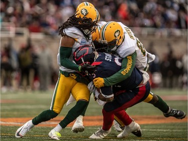Alouettes running back Ryder Stone (32) is tackled by Edmonton Eskimos defensive back Godfrey Onyeka (23), right, and Edmonton Eskimos linebacker Larry Dean (11) during CFL Eastern Semi-Final action at Molson Stadium in Montreal on Sunday, Nov. 10, 2019.