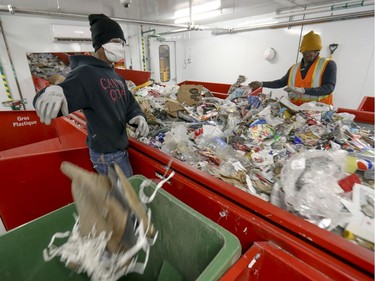 Workers sort recyclable materials at the new recycling plant in Lachine.