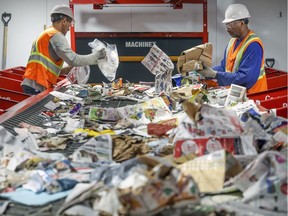 Workers sort recyclable materials at the new recycling plant in Lachine Nov. 12, 2019.