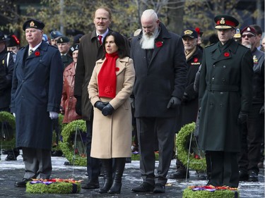 Montreal Mayor Valérie Plante is joined by city councillors Peter McQueen, left, and Sterling Downey during Remembrance Day ceremony at Place du Canada in Montreal on Monday, Nov. 11, 2019.