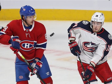Montreal Canadiens Ben Chiarot (8) and Columbus Blue Jackets' Pierre-Luc Dubois (18) keep their eyes on the flying puck, during first period NHL action in Montreal on Tuesday November 12, 2019.