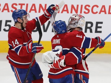 Montreal Canadiens Nick Suzuki (14) celebrates with goaltender Carey Price and Max Domi (13) following win against the Columbus Blue Jackets during shootout in NHL action in Montreal on Tuesday November 12, 2019.