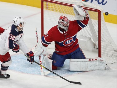 Montreal Canadiens goaltender Carey Price deflects puck on Columbus Blue Jackets Boone Jenner (38) during first period NHL action in Montreal on Tuesday November 12, 2019.