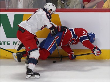 Montreal Canadiens Phillip Danault (24) goes down on puck on hit by Columbus Blue Jackets Ryan Murray (27) during first period NHL action in Montreal on Tuesday November 12, 2019.