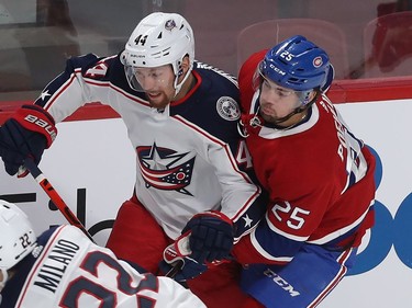 Montreal Canadiens center Ryan Poehling (25) gets in close on Columbus Blue Jackets Vladislav Gavrikov (44) during first period NHL action in Montreal on Tuesday November 12, 2019.