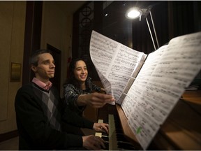 Organists Francine Nguyen-Savaria and Matthieu Latreille practice prior to a concert at St. John the Baptist Church in Pointe-Claire.