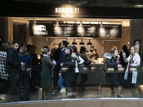 Customers wait in line for food at Time Out Market on Thursday November 14, 2019.