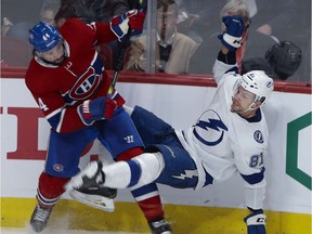Montreal Canadiens centre Nate Thompson dumps Tampa Bay Lightning defenceman Erik Cernak in Montreal, on Oct. 15, 2019.