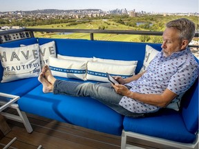 Tristan Jones relaxes on the balcony of his 19th floor Nuns' Island condominium.