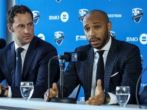 Montreal Impact sporting director Olivier Renard listens as French football legend Thierry Henry answers questions, at press conference introducing Henry as the team's new head coach in Montreal Monday Nov. 18, 2019.