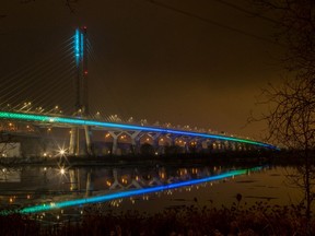The lights lining the new Champlain Bridge reflect in the St. Lawrence Seaway, seen from Brossard in November 2019.