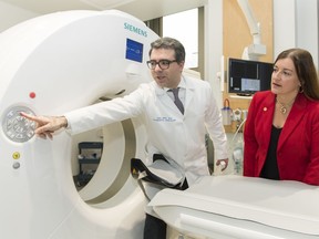 Dr. Fadi Aris, head of medical imaging for the West Island authority and Heather Holmes, managing director of the Lakeshore General Hospital Foundation discuss the new CT scanner at the hospital in Pointe-Claire.