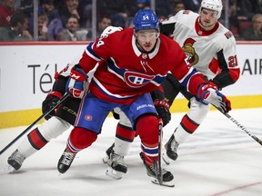 Montreal Canadiens' Charles Hudon chases the puck in front of Ottawa Senators' Dylan DeMelo, obscured, and Logan Brown during first period of game in Montreal on Nov. 20, 2019.