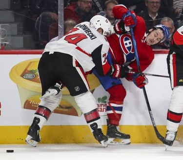 Montreal Canadiens Charles Hudon is knocked off the puck by Ottawa Senators Mark Borowiecki during first period of National Hockey League game in Montreal Wednesday November 20, 2019.
