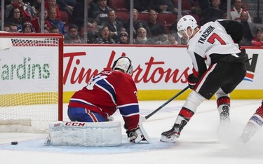 Brady Tkachuk of the Ottawa Senators slides the puck through Montreal Canadiens Carey Price's legs for the game-winning goal in overtime of National Hockey League game in Montreal Wednesday November 20, 2019.