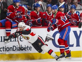 Canadiens' Nate Thompson checks Senators' Dylan DeMelo during first period Wednesday night at the Bell Centre.