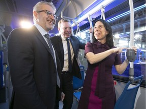Montreal Mayor Valerie Plante with Societe de transport de Montreal chairman Philippe Schnobb, centre, and STM director general Luc Tremblay, inside a new hybrid bus on Thursday November 21, 2019 following the STM 2020 budget announcement.  (Pierre Obendrauf / MONTREAL GAZETTE) ORG XMIT: 63530 - 3879