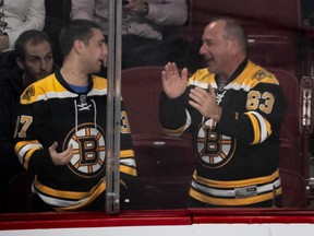 A couple of Boston Bruins fans celebrate at the Bell Centre in Montreal after an 8-1 win over the Canadiens on Nov. 26, 2019.