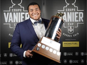 Andrew Seinet-Spaulding poses with the Metras Trophy at the recent Vanier Cup awards gala.