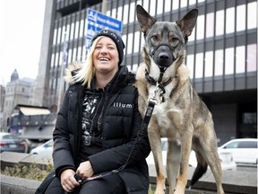 Jennifer Paquette and her dog, Clumsy, sit in a parking lot where she had a confrontation with Montreal police in 2014.