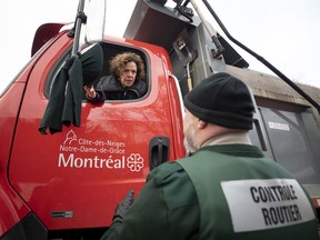 Sue Montgomery, mayor of the C.D.N.-N.D.G. borough, listens to route-control officer Denis Poirier after she failed to locate him in a truck's mirrors as part of a pedestrian safety demonstration in Montreal on Thursday, Nov. 28, 2019.