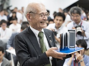 Akira Yoshino holds a model of a lithium-ion battery during a news conference in Tokyo. Yoshino won the 2019 Nobel Prize in chemistry with John B. Goodenough and M. Stanley Whittingham.