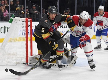 Deryk Engelland #5 of the Vegas Golden Knights and Shea Weber #6 of the Montreal Canadiens fight for the puck in the third period.