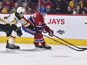 Canadiens' Jesperi Kotkaniemiskates the puck against Charlie McAvoy of the Boston Bruins at the Bell Centre on Tuesday, Nov. 26, 2019, in Montreal.