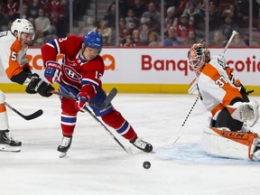 Canadiens' Max Domi has his stick lifted by Philadelphia Flyers Philippe Myers as he breaks in on goalie Brian Elliott in Montreal on Saturday, Nov. 30, 2019.