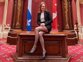 Québec solidaire MNA Catherine Dorion sits on the main desk of the Salon rouge at the National Assembly in Quebec City, in a photo she posted to Facebook on Oct. 31, 2019. The photo caused some controversy among fellow legislators for its apparent lack of respect for the chamber. (Catherine Dorion via Facebook)