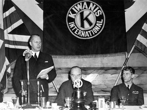 Flying ace George "Buzz" Beurling (right) was a guest of honour at a Kiwanis Club lunch at the Windsor Hotel in Montreal on Nov. 12, 1942. Standing at the microphone is George Drew, then Ontario Conservative leader (later premier). Kiwanis Club official Henry B. Mulvena is in the middle.