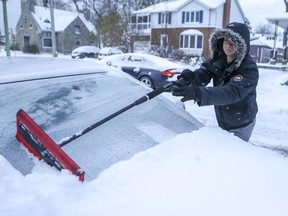 Vitali Obraztsov clears snow from his car in the Lachine borough of Montreal Tuesday November 12, 2019. "Ordinarily, minus-20 degree weather (including wind chill) would not make us flinch. But it does cause some concern given how early in the season it has come," Fariha Naqvi-Mohamed writes.