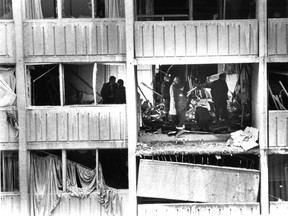 Police investigators search the rubble for clues after a bomb exploded in a ninth-floor apartment at 1645 de Maisonneuve W. on Nov. 25, 1984.