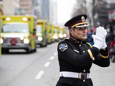 An Urgences-santé representative waves to the crowd during the annual Santa Claus parade in Montreal on Saturday, Nov. 23, 2019.