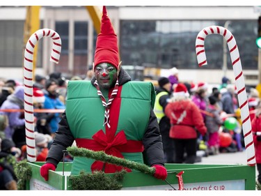 An elf performs for the crowd during the annual Santa Claus parade in Montreal on Saturday, Nov. 23, 2019.