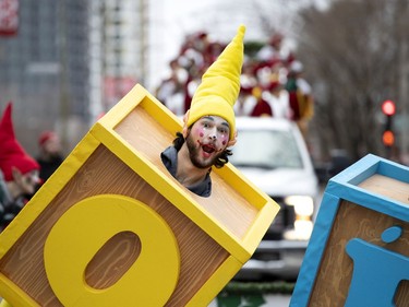 An elf performs for the crowd during the annual Santa Claus parade in Montreal on Saturday, Nov. 23, 2019.