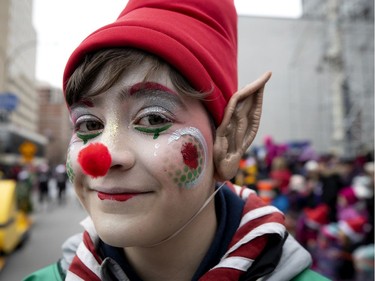 An elf performs for the crowd during the annual Santa Claus parade in Montreal on Saturday, Nov. 23, 2019.
