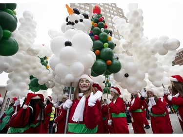 One of Santa's many helpers performs for the crowd during the annual Santa Claus parade in Montreal on Saturday, Nov. 23, 2019.