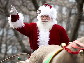 Santa waves to the crowd during the annual Santa Claus parade in Montreal Nov. 23, 2019.